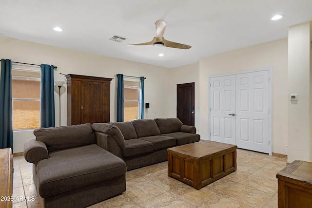 living area featuring ceiling fan, healthy amount of natural light, and recessed lighting