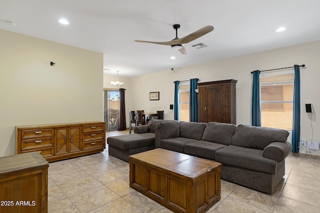 living area with a chandelier, ceiling fan, recessed lighting, and light tile patterned flooring
