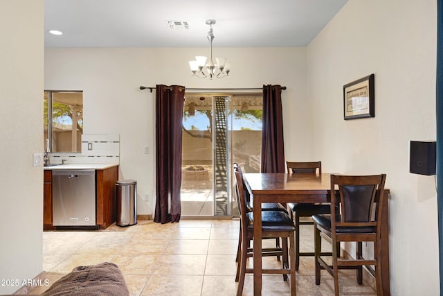 dining area featuring a chandelier, plenty of natural light, and light tile patterned floors