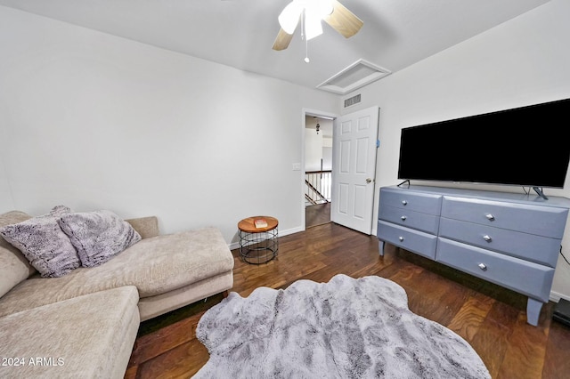 living room featuring dark wood-type flooring and ceiling fan