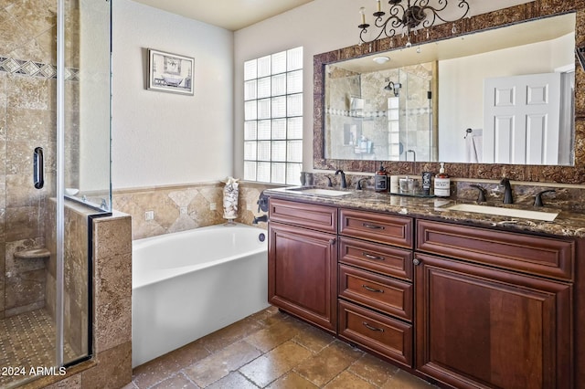 bathroom featuring shower with separate bathtub and vanity