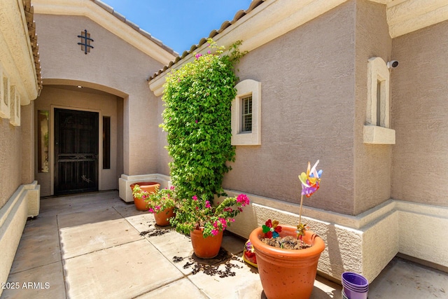 1865 E Locust Pl, Chandler, AZ 85286 - view of exterior entry with stucco siding and a patio area
