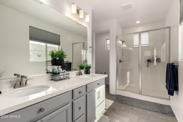 bathroom featuring vanity, wood-type flooring, and walk in shower