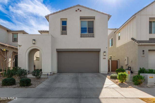 mediterranean / spanish home with a garage