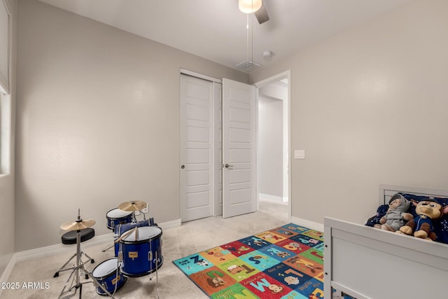 bedroom featuring light carpet, ceiling fan, and a closet