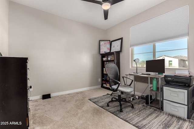 carpeted office space with ceiling fan