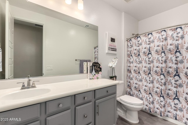 bathroom with vanity, curtained shower, wood-type flooring, and toilet