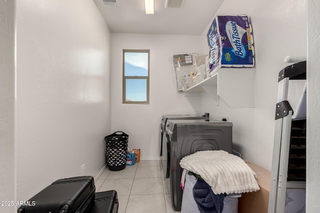 clothes washing area featuring light tile patterned flooring and independent washer and dryer