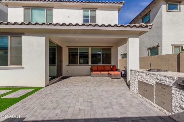 view of patio / terrace with area for grilling and sink