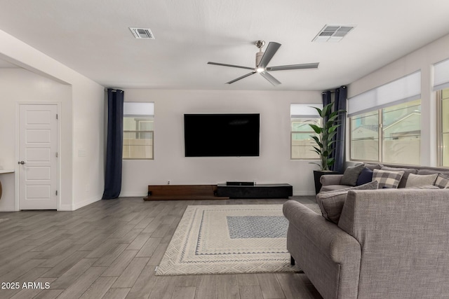 living room featuring light hardwood / wood-style flooring and ceiling fan