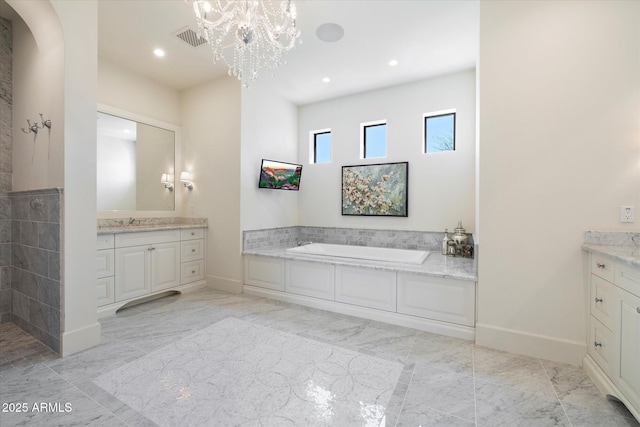 bathroom with marble finish floor, visible vents, a bath, and vanity