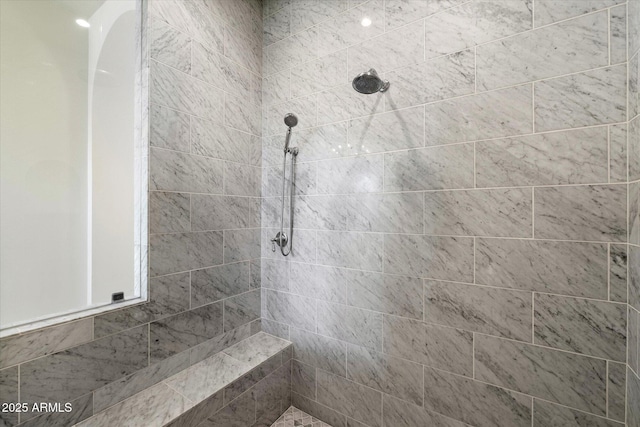 full bath featuring tiled shower