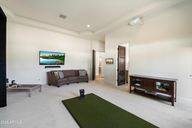 living area with carpet floors, recessed lighting, visible vents, and baseboards