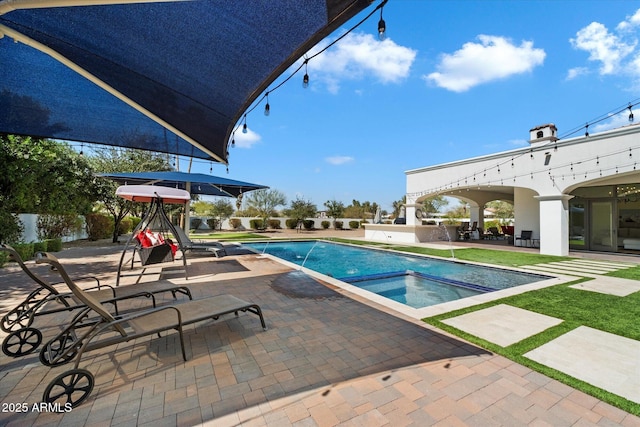 view of pool featuring a pool with connected hot tub and a patio