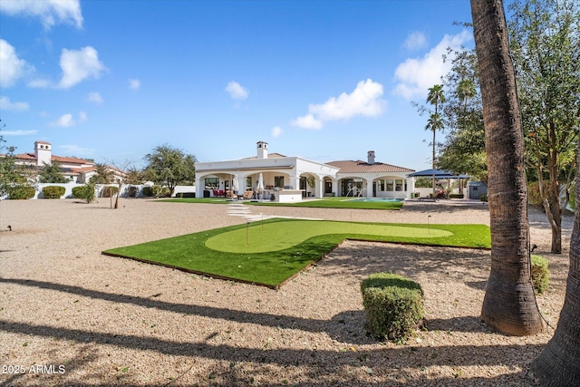 rear view of property with a chimney, a patio, and a gazebo