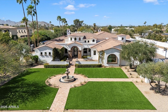 view of front of house featuring a front yard, a tiled roof, and stucco siding