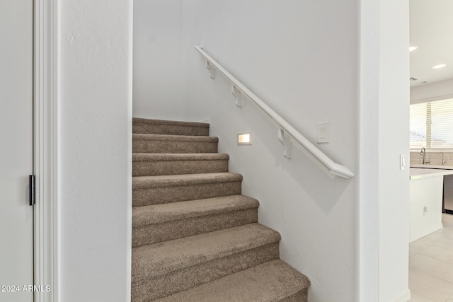 stairs featuring tile patterned flooring