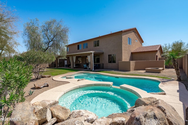 view of swimming pool with a fenced backyard, a pool with connected hot tub, and a patio