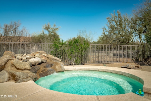 view of pool with a hot tub and fence