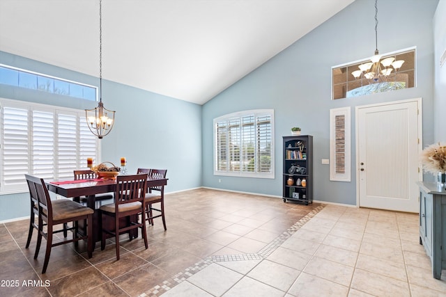 dining area with baseboards, a notable chandelier, and tile patterned flooring