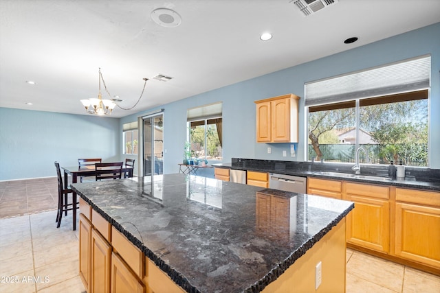 kitchen featuring visible vents, a sink, a center island, recessed lighting, and dishwasher