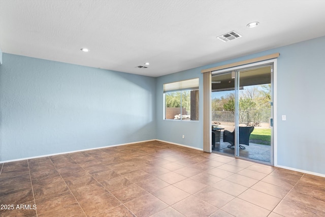 spare room with visible vents, recessed lighting, and baseboards