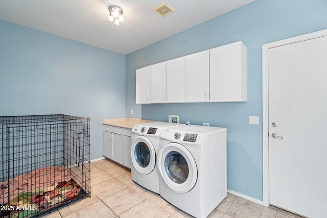 washroom featuring cabinet space, separate washer and dryer, visible vents, and baseboards