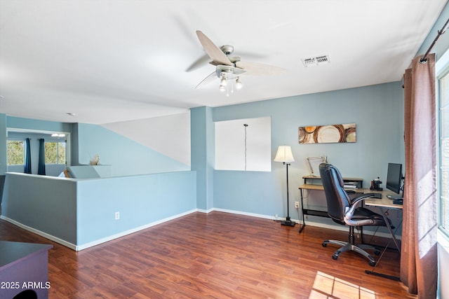 office space with visible vents, a ceiling fan, baseboards, and wood finished floors