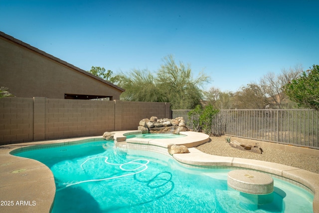 view of pool with a pool with connected hot tub and a fenced backyard