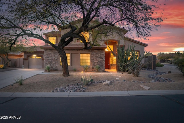 view of front of property featuring stone siding, stucco siding, driveway, and a garage