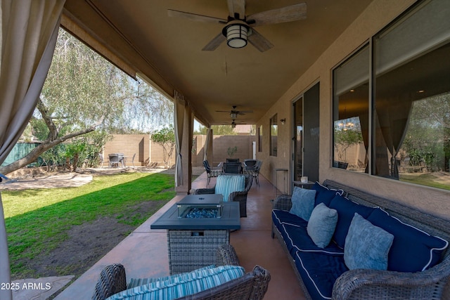 view of patio featuring outdoor dining area, an outdoor living space with a fire pit, fence private yard, and a ceiling fan