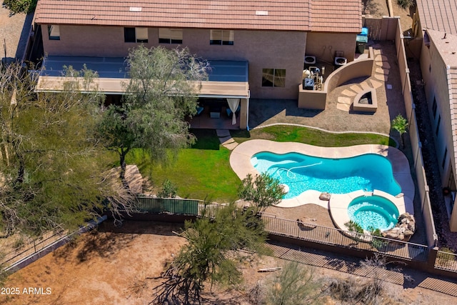 view of pool with a pool with connected hot tub, a fenced backyard, and a patio area