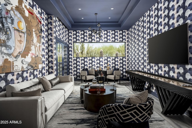 living room with wallpapered walls, a tray ceiling, wood finished floors, and recessed lighting