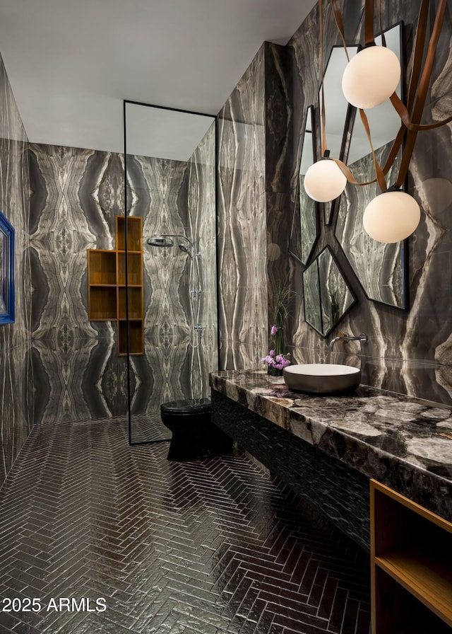 full bath with vanity and a marble finish shower