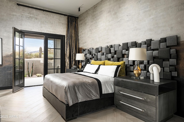 bedroom featuring a towering ceiling and access to exterior