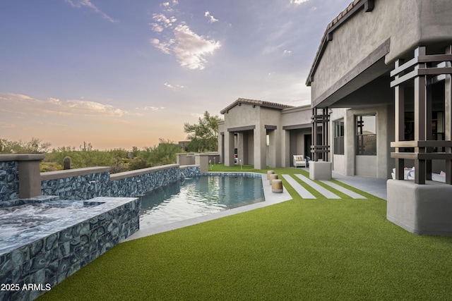 outdoor pool with a yard and a patio