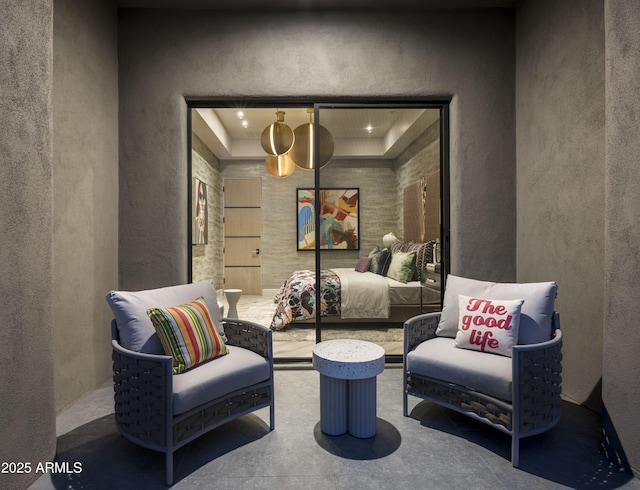 interior space featuring a raised ceiling and concrete floors