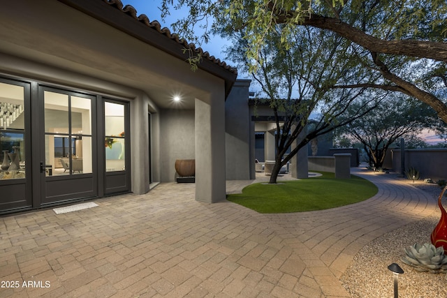 view of patio / terrace featuring fence and french doors