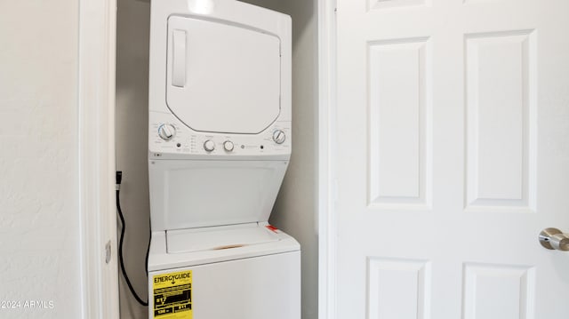 washroom with stacked washing maching and dryer