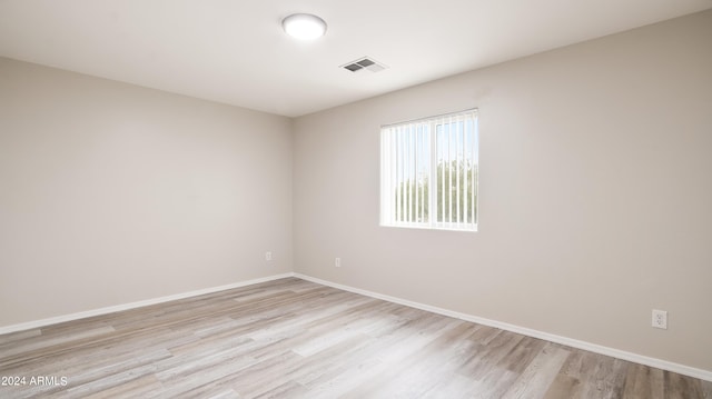 spare room with light hardwood / wood-style flooring