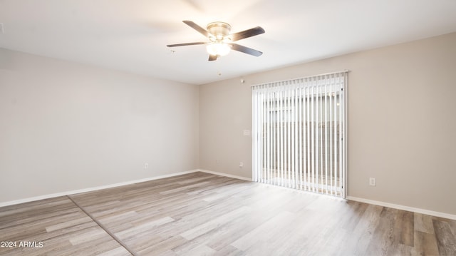 empty room with ceiling fan and light hardwood / wood-style floors