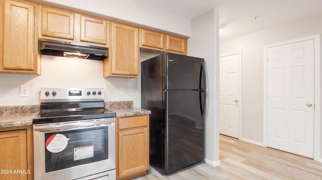 kitchen featuring stainless steel electric range, black fridge, light wood-type flooring, and light brown cabinets