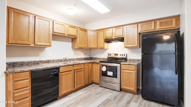 kitchen featuring black appliances, sink, and light hardwood / wood-style floors