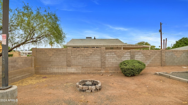 view of yard with an outdoor fire pit