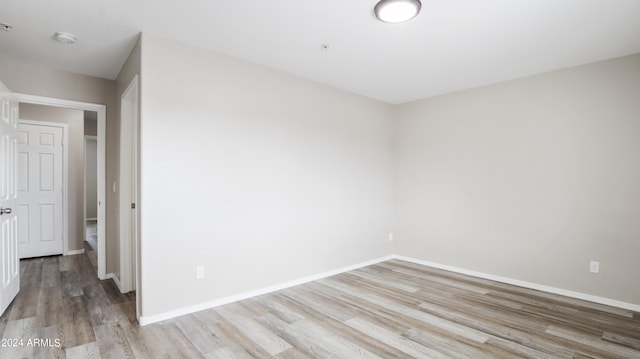 unfurnished room with wood-type flooring