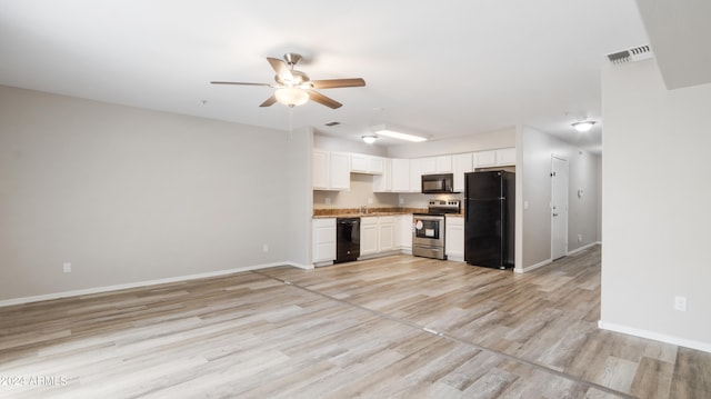 interior space with light hardwood / wood-style floors, black appliances, white cabinets, sink, and ceiling fan