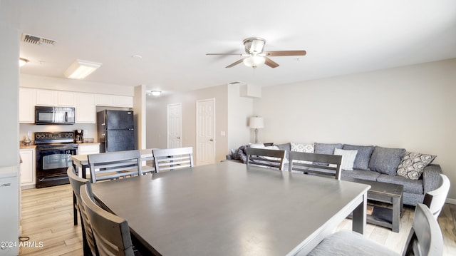 dining room with ceiling fan and light hardwood / wood-style floors