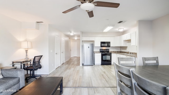 living room with ceiling fan, light wood-type flooring, and sink