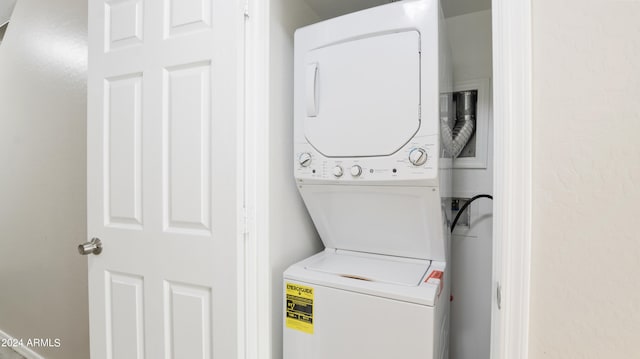 laundry room with stacked washing maching and dryer