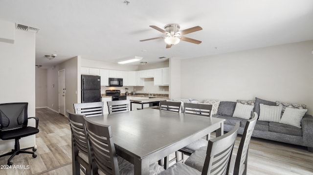 dining area featuring ceiling fan and light hardwood / wood-style flooring